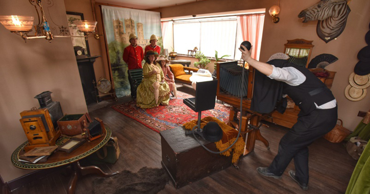 people getting their photo taken in the 1900s photo studio at Beamish Museum